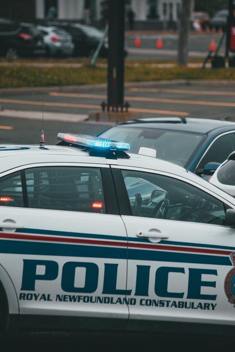 white and blue police car on road during daytime