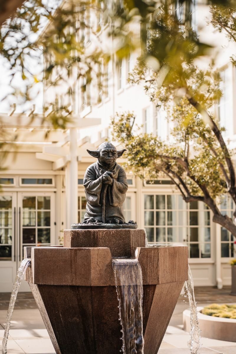 Yoda fountain in front of Lucasfilm office, San Francisco, surrounded by greenery.
