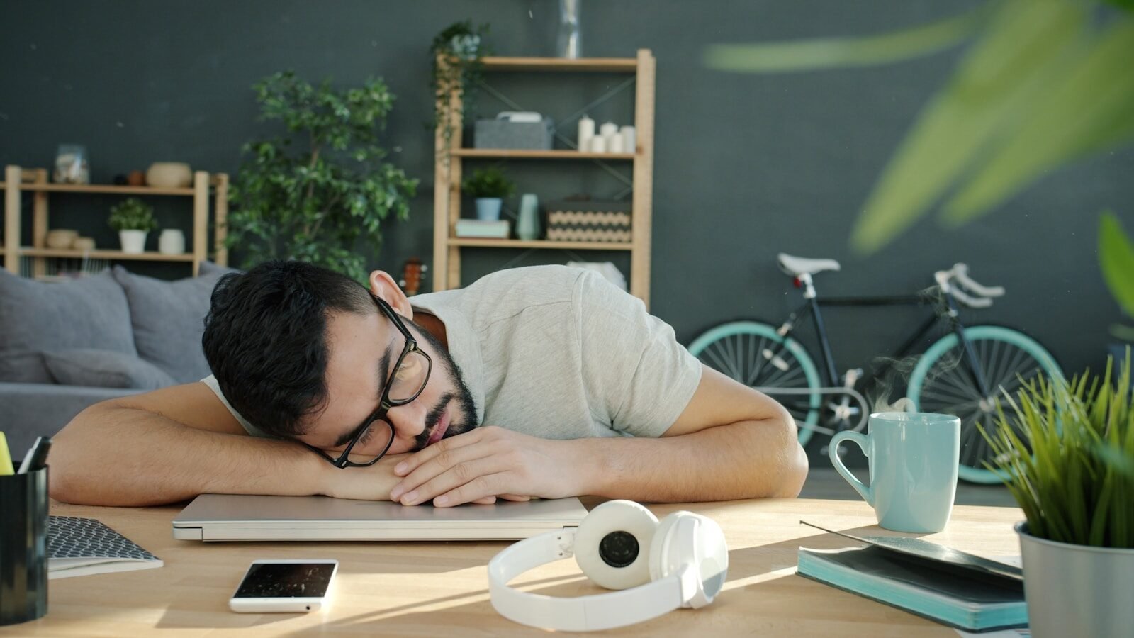 Man sleeping on a laptop at a desk